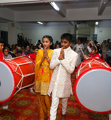 School cultural performance with student Jainam playing traditional drums