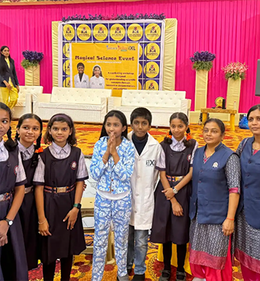 Students and teachers posing together at an educational event with Jainam and Jivika
