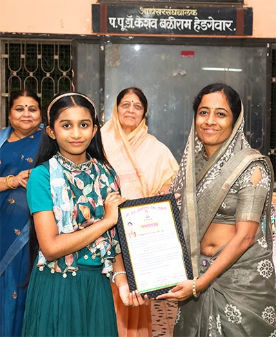 Jivika receiving recognition at an event